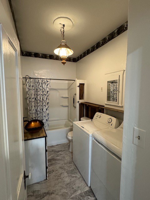 washroom featuring washer and clothes dryer