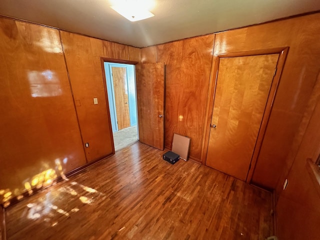 644 4th Ave E, Superior, MT 59872 - unfurnished bedroom featuring wood finished floors and wood walls