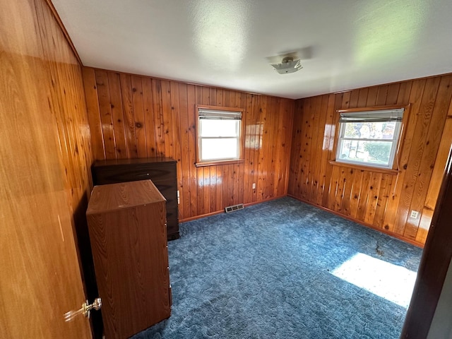 644 4th Ave E, Superior, MT 59872 - carpeted spare room featuring healthy amount of natural light and wood walls