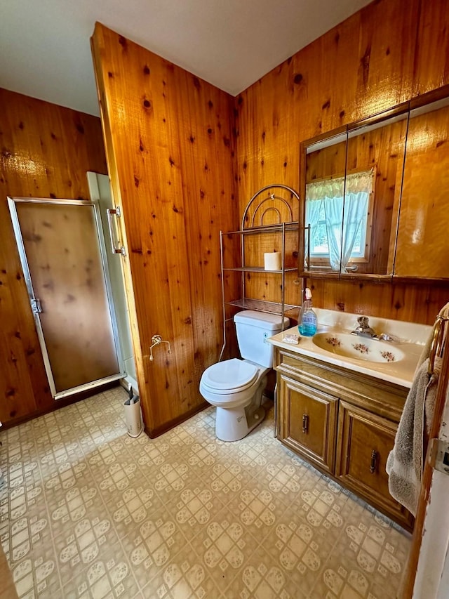 644 4th Ave E, Superior, MT 59872 - full bathroom featuring wood walls, a shower stall, toilet, vanity, and tile patterned floors