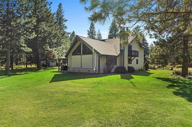 view of property exterior with a lawn and a chimney