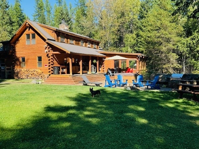 rear view of house with a yard