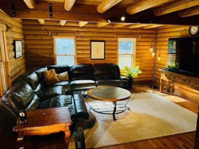 living room featuring rustic walls and beam ceiling