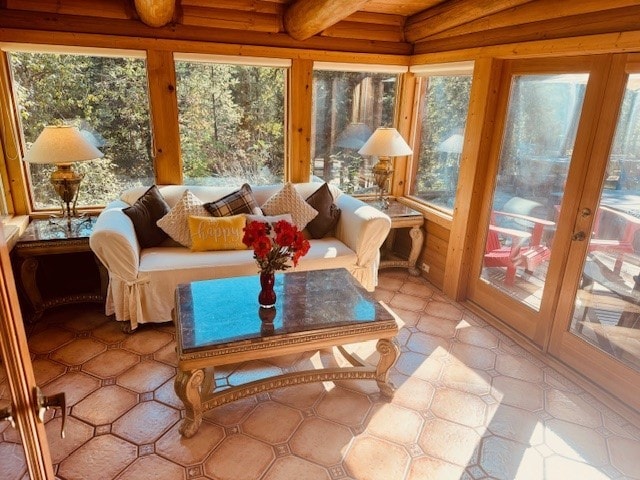 sunroom / solarium featuring beam ceiling