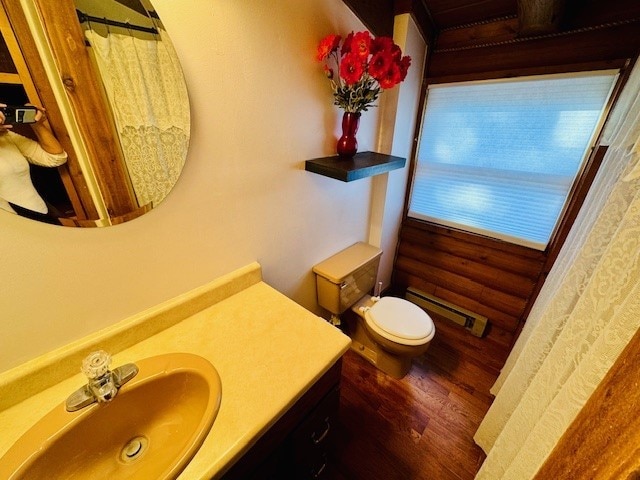 bathroom featuring a baseboard radiator, hardwood / wood-style floors, vanity, and toilet