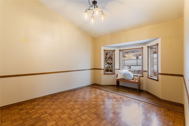 unfurnished room with parquet floors and a chandelier