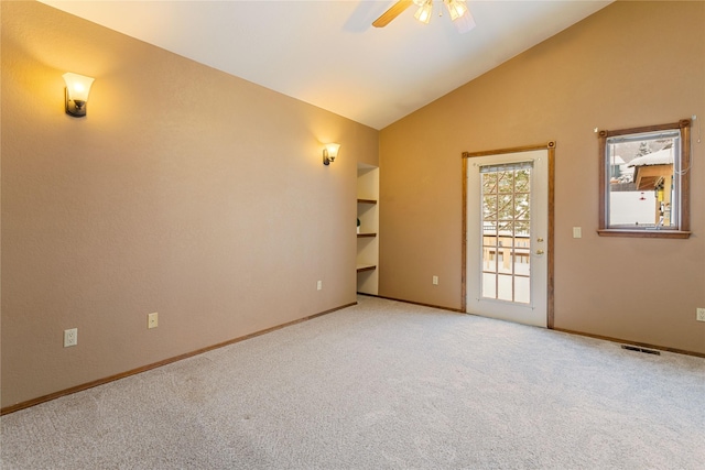 carpeted empty room with ceiling fan and vaulted ceiling