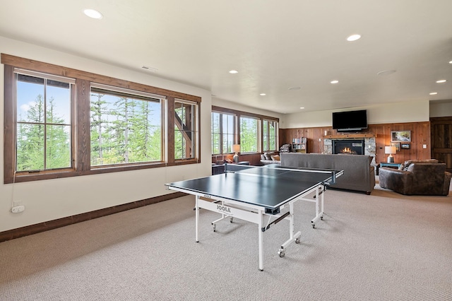 game room with wood walls and light colored carpet