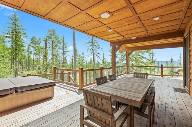 wooden deck with a covered hot tub