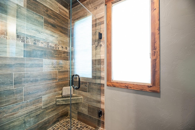 bathroom with a shower with shower door