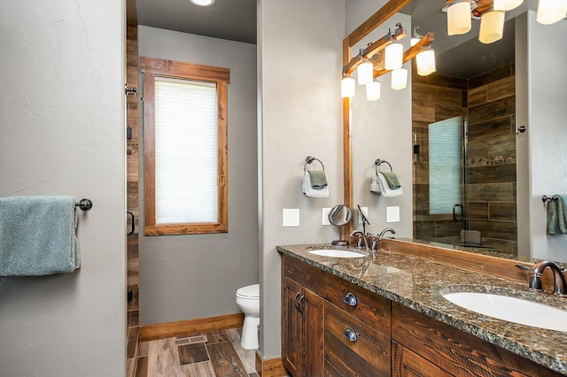 bathroom featuring vanity, toilet, and walk in shower