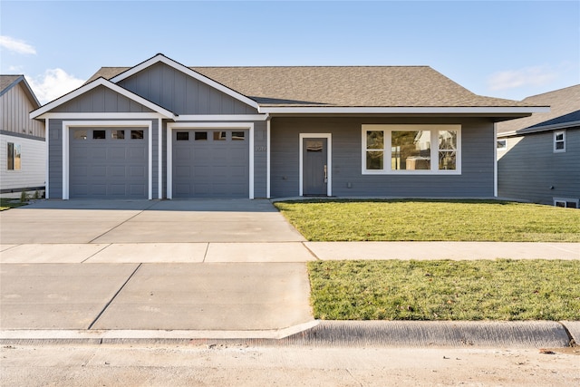 view of front of property with a garage and a front yard