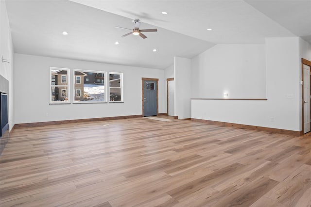 unfurnished living room featuring lofted ceiling, ceiling fan, and light hardwood / wood-style flooring