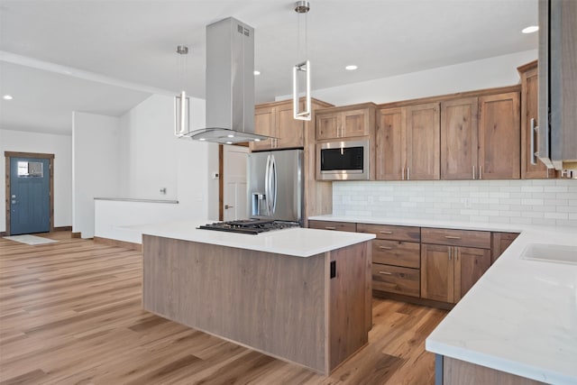 kitchen with a kitchen island, appliances with stainless steel finishes, pendant lighting, island range hood, and decorative backsplash