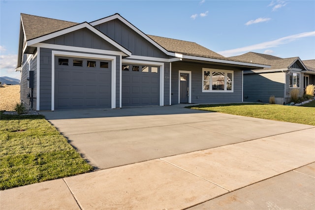 view of front of house featuring a garage and a front lawn