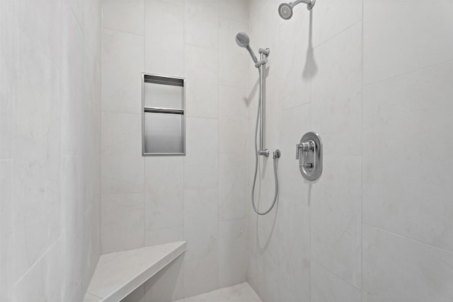 bathroom with a tile shower