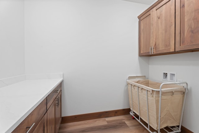 laundry room with cabinets, washer hookup, and hardwood / wood-style floors