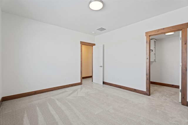 unfurnished bedroom featuring a closet and light carpet