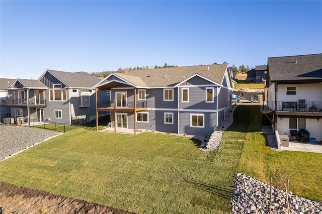 back of property with a lawn and a patio area