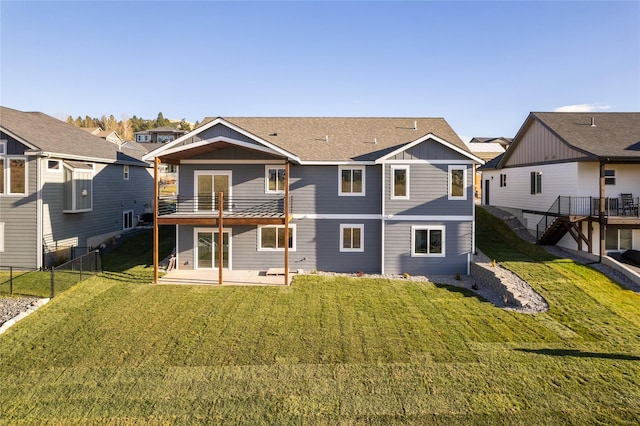 rear view of house with a yard and a patio area