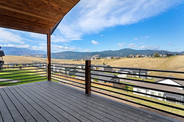 wooden deck with a mountain view and a rural view