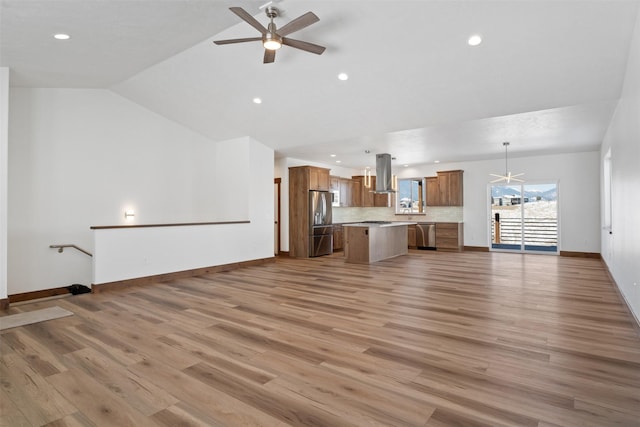 unfurnished living room featuring ceiling fan, lofted ceiling, and light hardwood / wood-style floors