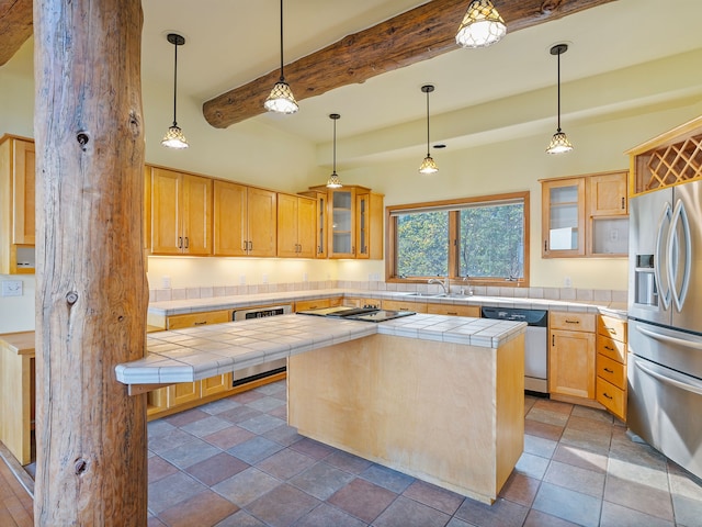 kitchen featuring stainless steel appliances, tile countertops, beam ceiling, a center island, and sink