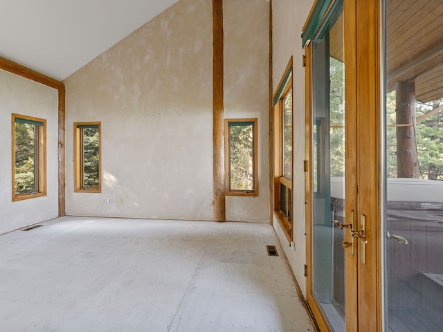 unfurnished room featuring high vaulted ceiling