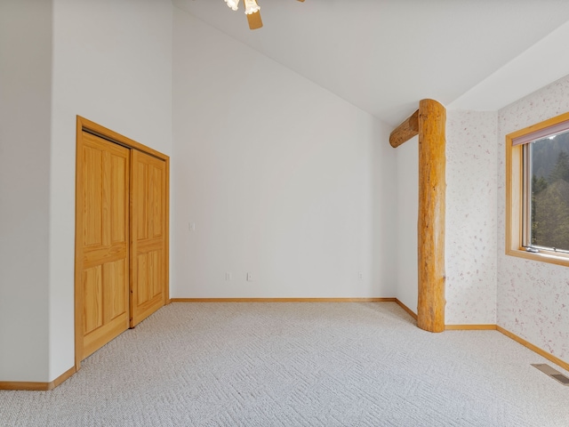 interior space featuring vaulted ceiling, ceiling fan, and light colored carpet