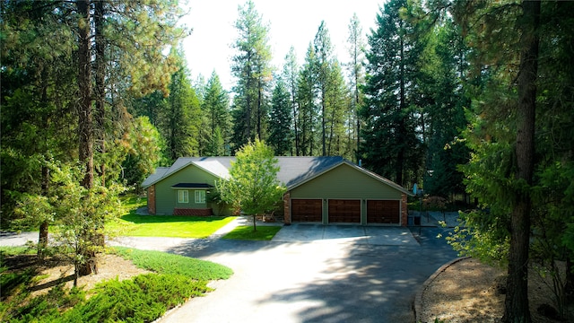 ranch-style home featuring a front yard and a garage