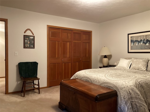 bedroom with light carpet and a closet