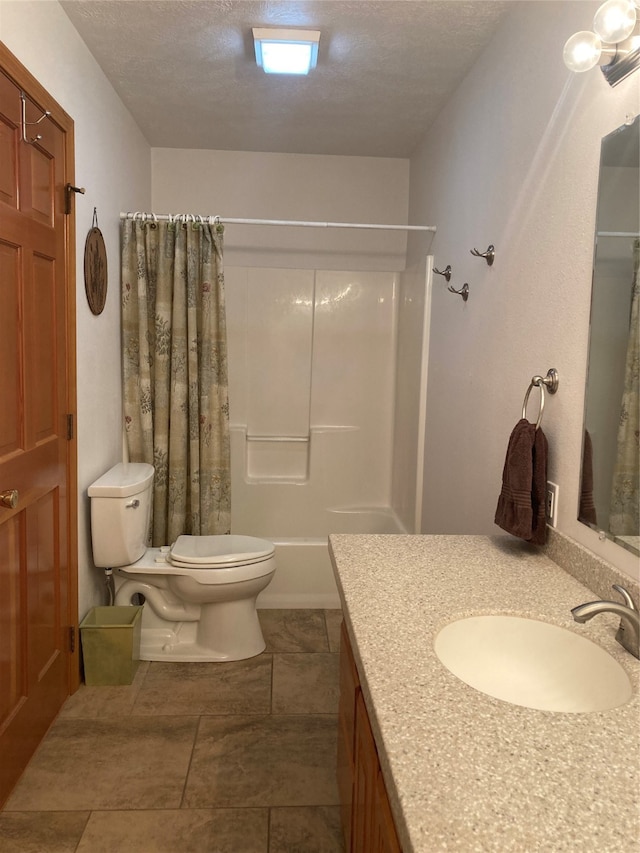 full bathroom with shower / tub combo with curtain, a textured ceiling, vanity, and toilet