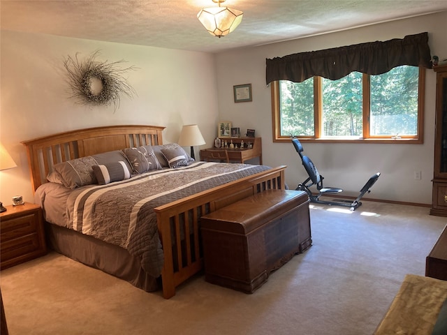 bedroom featuring a textured ceiling and light carpet