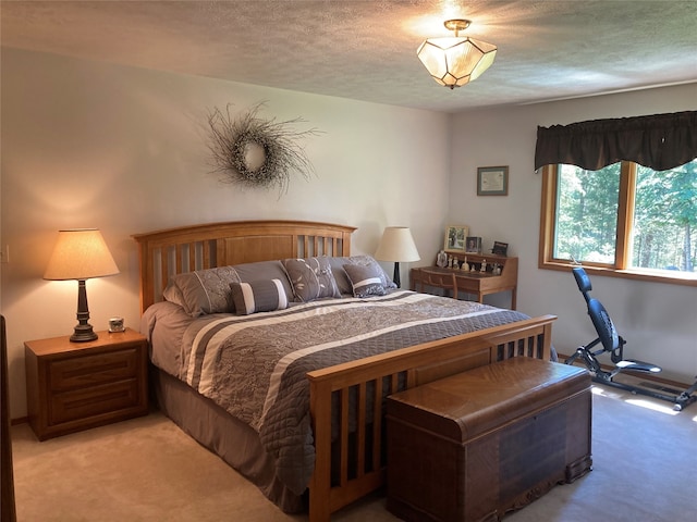 bedroom with a textured ceiling and light carpet