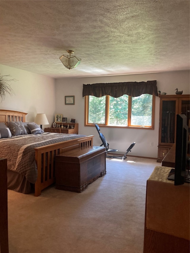 bedroom featuring light colored carpet and a textured ceiling