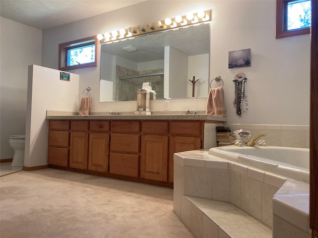 full bathroom with vanity, shower with separate bathtub, toilet, and a textured ceiling