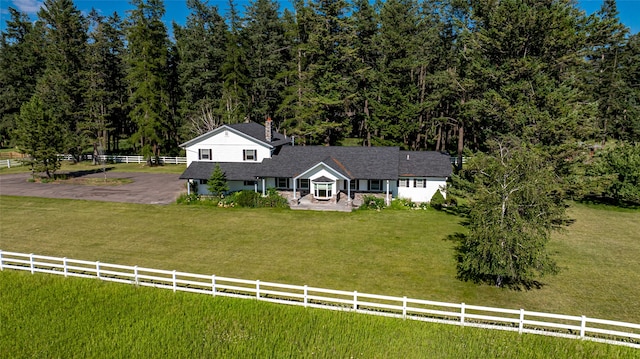 view of front facade featuring a front lawn and a rural view