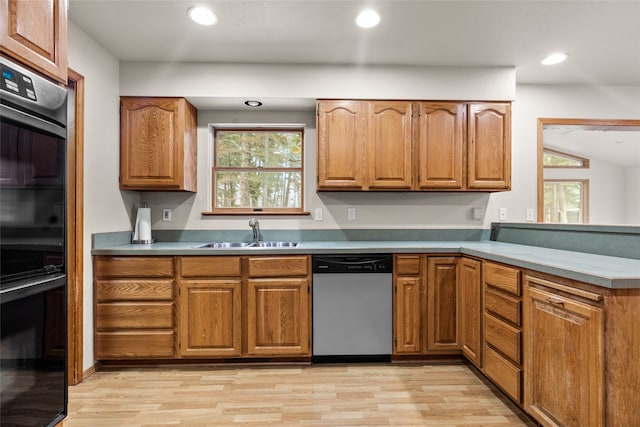 kitchen featuring dishwasher, light wood-type flooring, a wealth of natural light, and sink