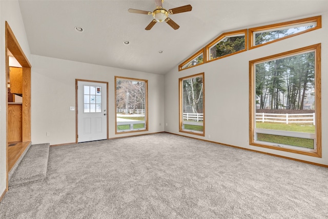 unfurnished living room featuring ceiling fan, carpet floors, and lofted ceiling