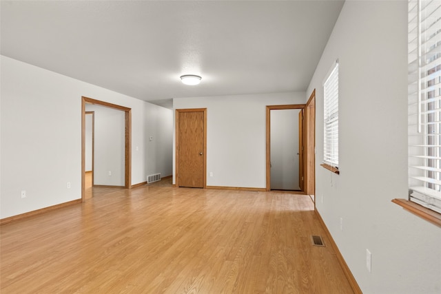 spare room with light wood-type flooring