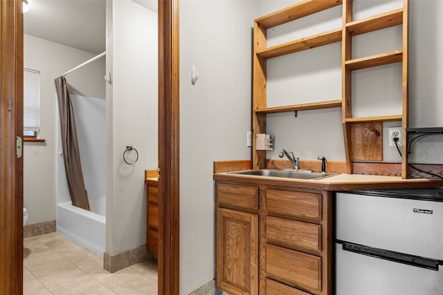 full bathroom featuring tile patterned flooring, vanity, toilet, and shower / tub combo with curtain