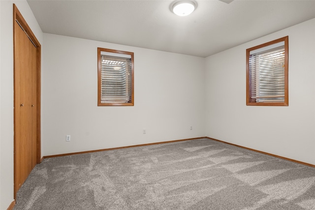 unfurnished bedroom featuring carpet and a closet