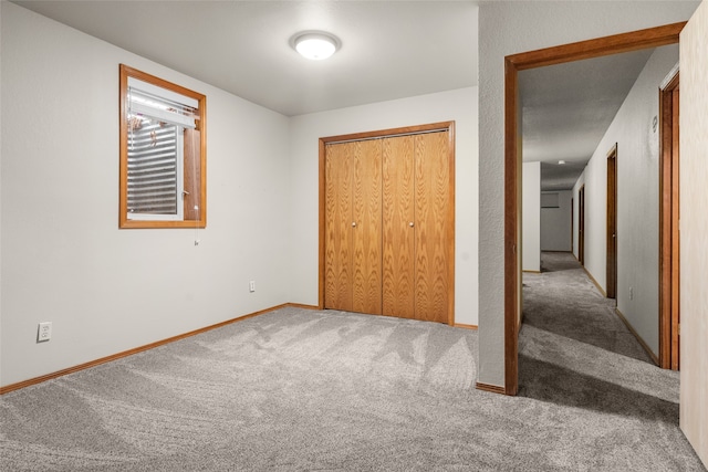 unfurnished bedroom featuring carpet flooring and a closet