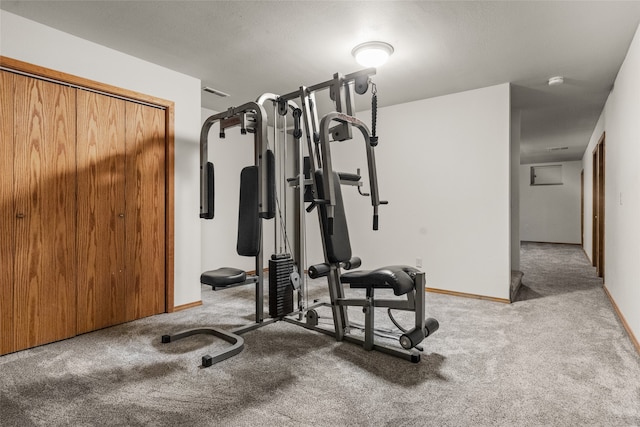 exercise room featuring light colored carpet