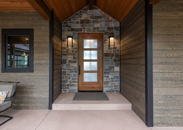 doorway to property featuring stone siding