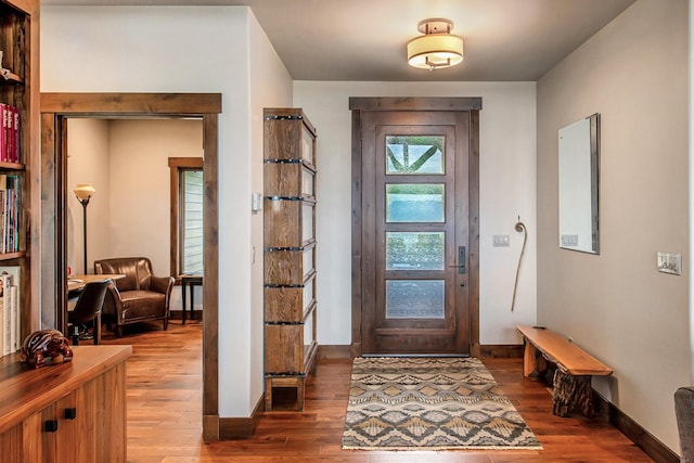 entryway featuring baseboards and wood finished floors