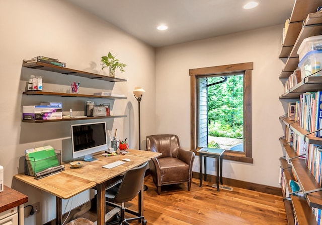 office featuring recessed lighting, baseboards, light wood-type flooring, and visible vents