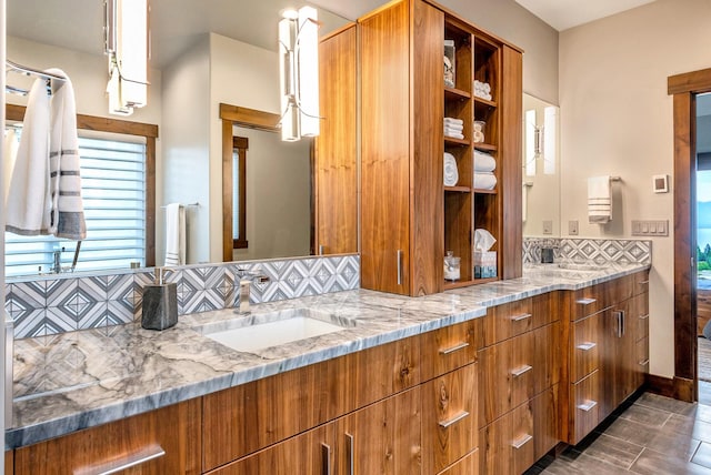 full bath with double vanity, a sink, and tasteful backsplash