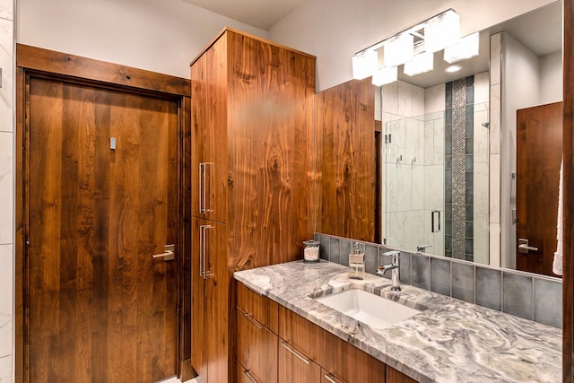 bathroom with vanity and tiled shower
