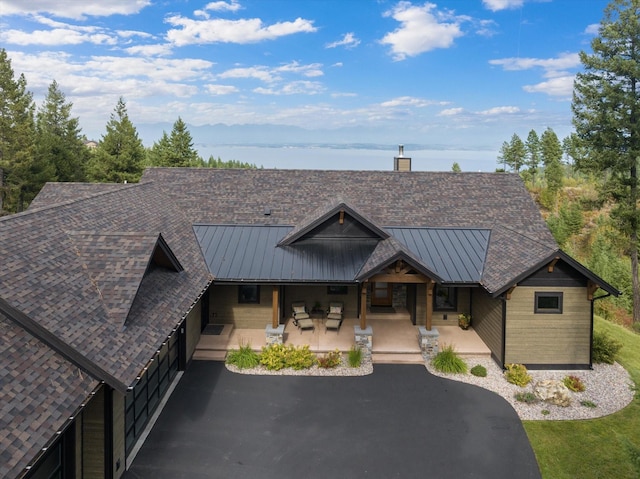 view of front of home featuring a porch, a standing seam roof, and metal roof